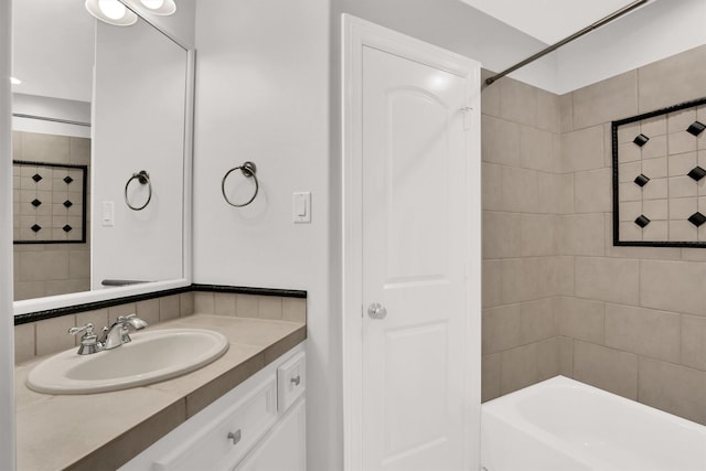 bathroom featuring vanity and tiled shower / bath