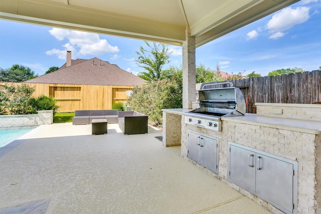 view of patio / terrace featuring exterior kitchen, outdoor lounge area, and a grill