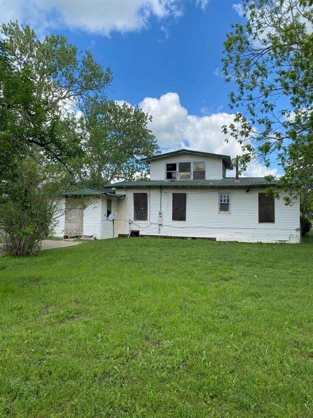 rear view of property with a yard