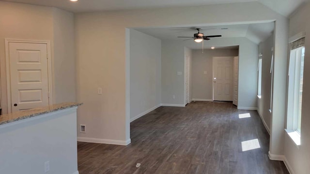 empty room with ceiling fan and dark hardwood / wood-style flooring