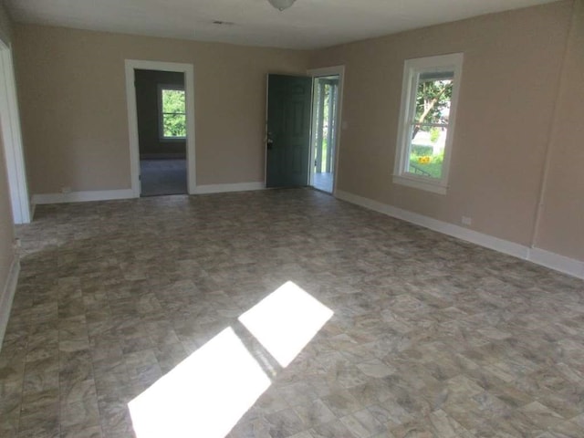 unfurnished room featuring plenty of natural light