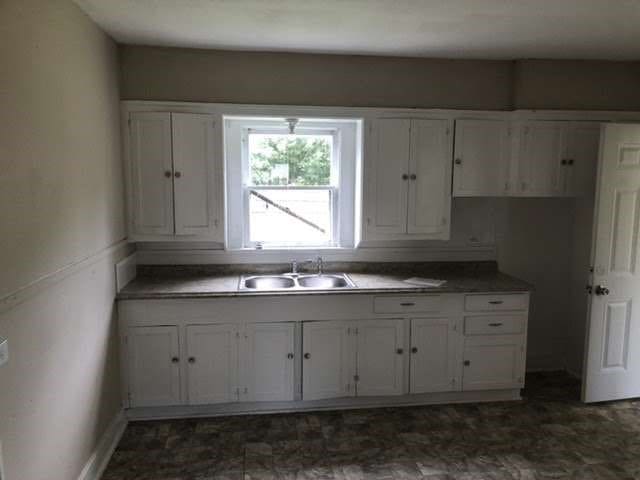 kitchen featuring sink and white cabinets