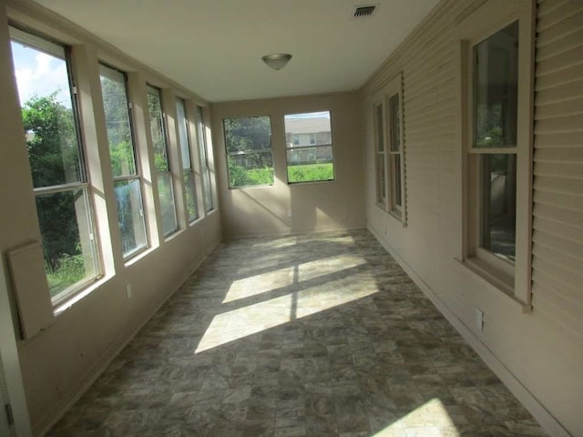 unfurnished sunroom featuring a wealth of natural light