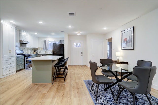 dining space with light hardwood / wood-style flooring