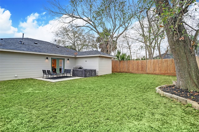 view of yard with french doors and a patio area