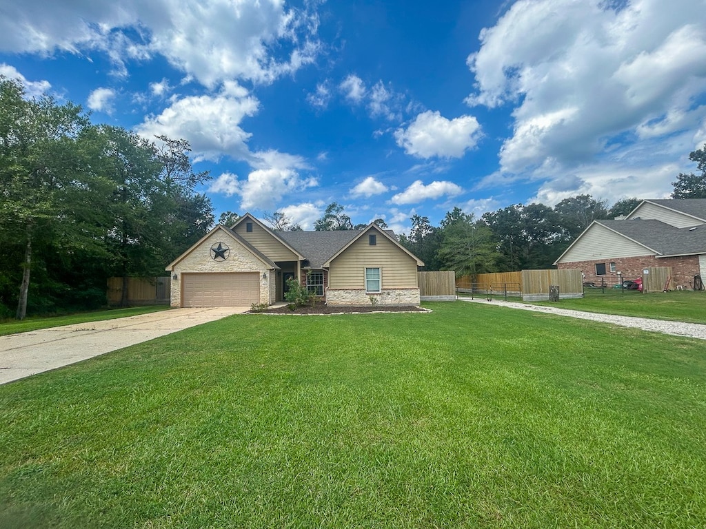 view of front of property featuring a garage and a front lawn