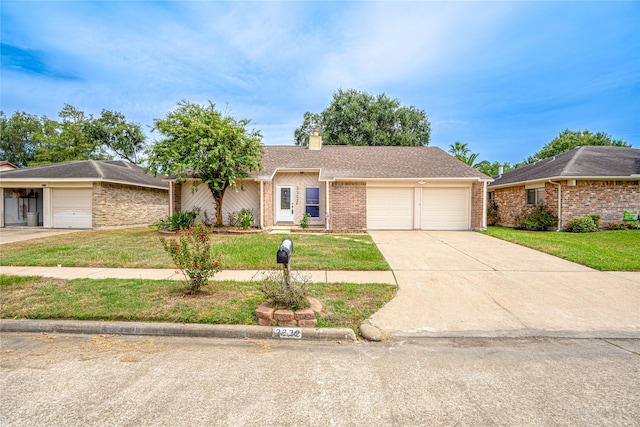 single story home with a garage and a front yard