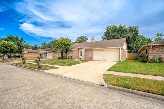 view of front of house with a garage and a front lawn