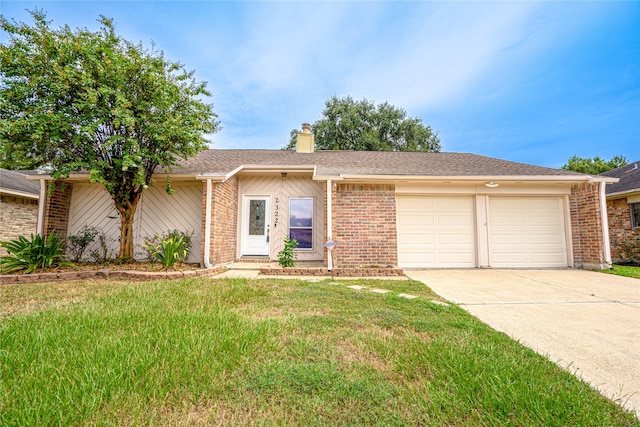 ranch-style house with a front yard and a garage