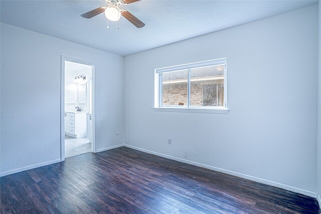 spare room featuring sink, ceiling fan, dark hardwood / wood-style flooring, and a textured ceiling