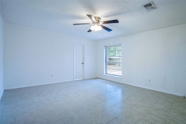 unfurnished room featuring a textured ceiling and ceiling fan