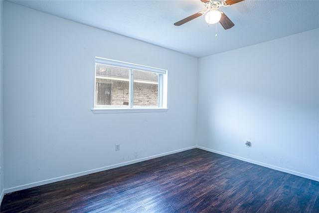 unfurnished room featuring dark wood-type flooring and ceiling fan