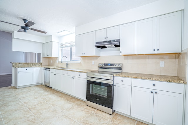 kitchen featuring light stone countertops, stainless steel appliances, white cabinetry, sink, and ceiling fan