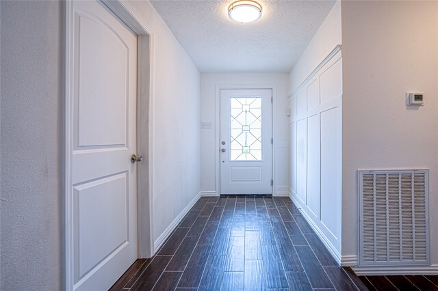 entryway featuring a textured ceiling