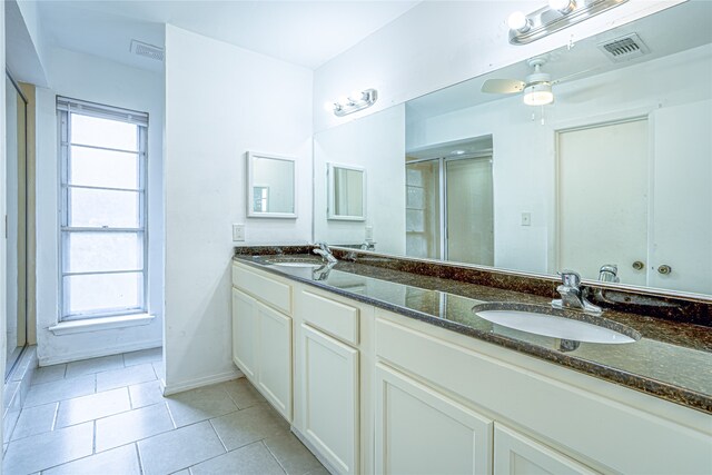 bathroom featuring vanity, a shower with shower door, ceiling fan, and tile patterned flooring