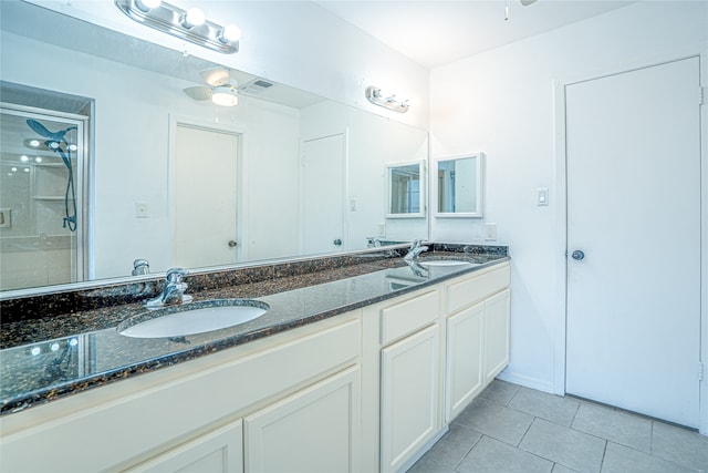 bathroom with vanity, a shower with shower door, ceiling fan, and tile patterned flooring