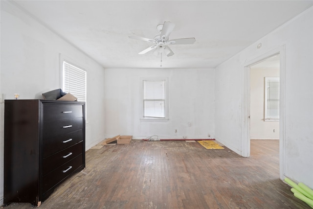 interior space with dark wood-type flooring and ceiling fan