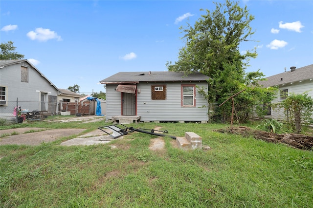 rear view of house featuring a yard