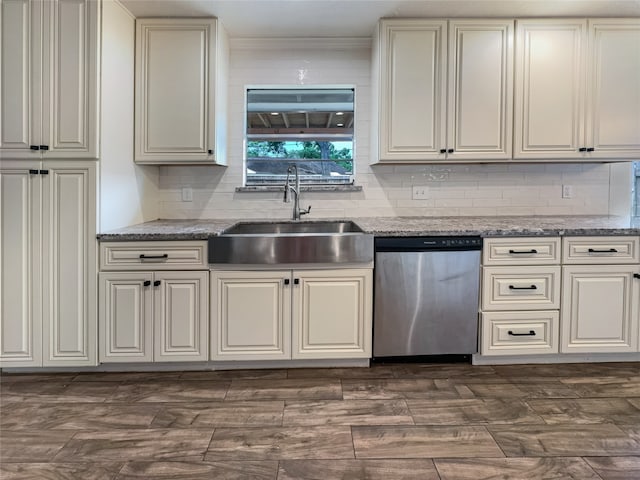 kitchen featuring dishwasher, crown molding, sink, and decorative backsplash