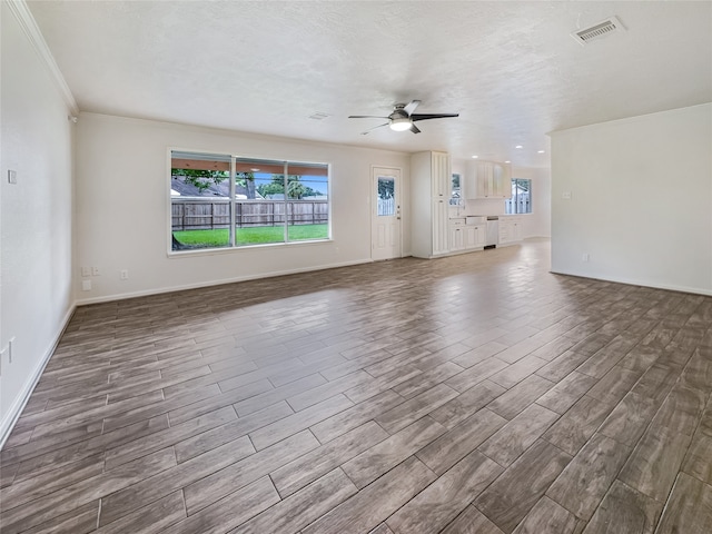 unfurnished living room featuring ornamental molding, a textured ceiling, hardwood / wood-style floors, and ceiling fan