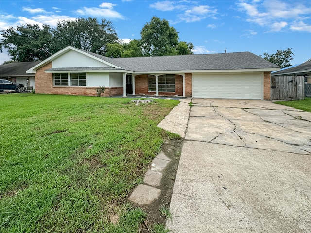 ranch-style home with a garage and a front lawn