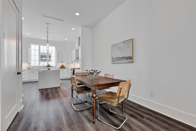 dining room featuring sink and dark hardwood / wood-style flooring