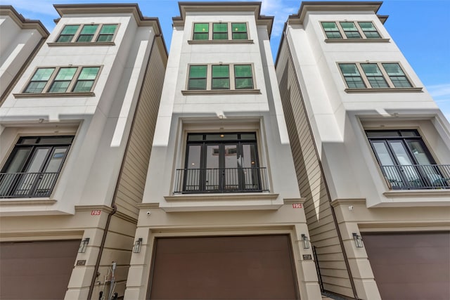 view of front of house featuring a balcony and a garage