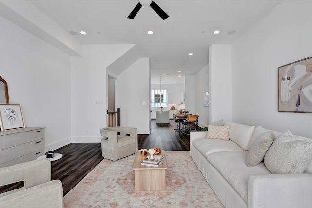 living room featuring dark wood-type flooring and ceiling fan