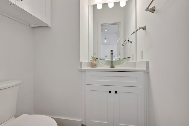 bathroom featuring toilet and vanity