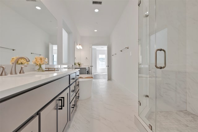 bathroom with vanity and shower with separate bathtub