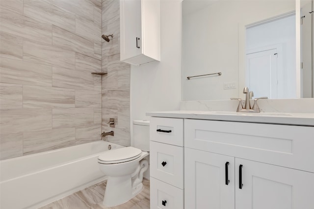 full bathroom with tiled shower / bath, vanity, toilet, and hardwood / wood-style flooring