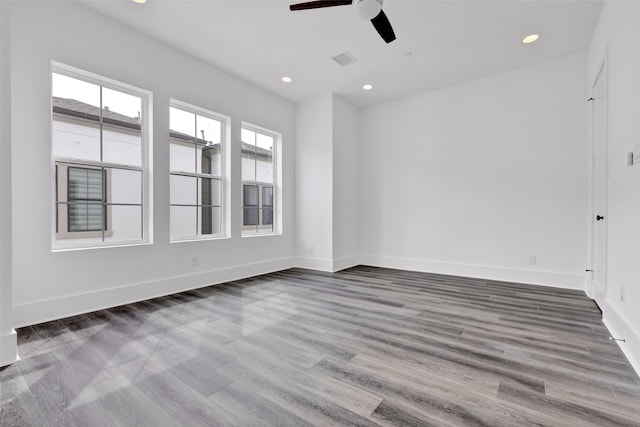 empty room with ceiling fan and hardwood / wood-style flooring