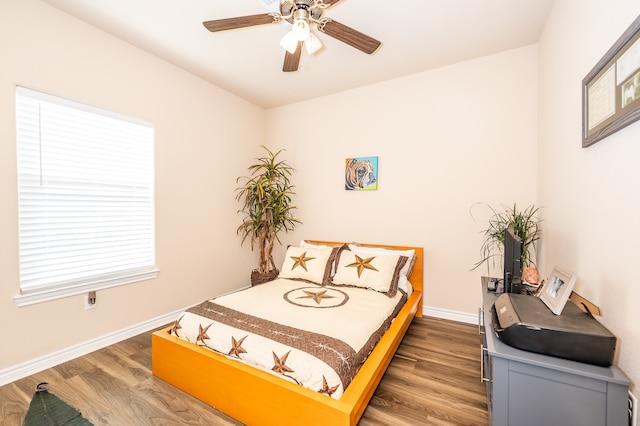 bedroom with hardwood / wood-style floors and ceiling fan