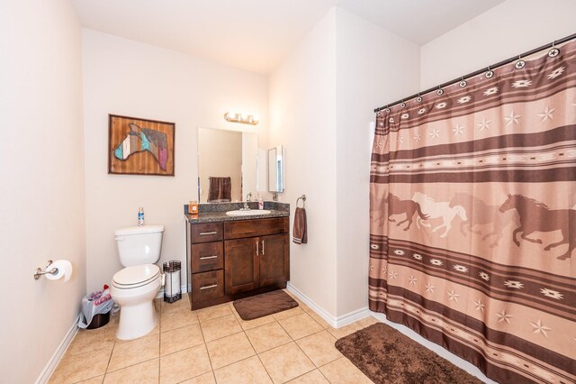 bathroom featuring a shower with shower curtain, vanity, toilet, and tile patterned floors