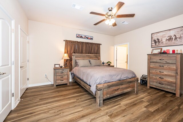 bedroom with dark wood-type flooring and ceiling fan