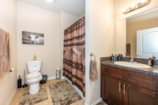 bathroom featuring tile patterned flooring, vanity, toilet, and curtained shower