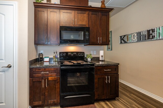 kitchen featuring black appliances, dark stone countertops, and dark hardwood / wood-style floors