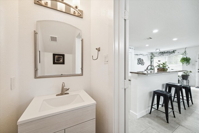 bathroom with tile patterned flooring and vanity