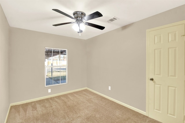 carpeted spare room with ceiling fan