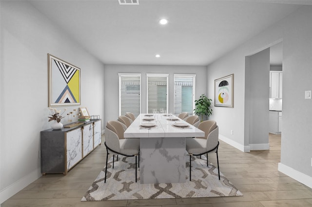 dining space with light hardwood / wood-style flooring