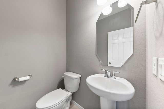 bathroom featuring toilet and sink