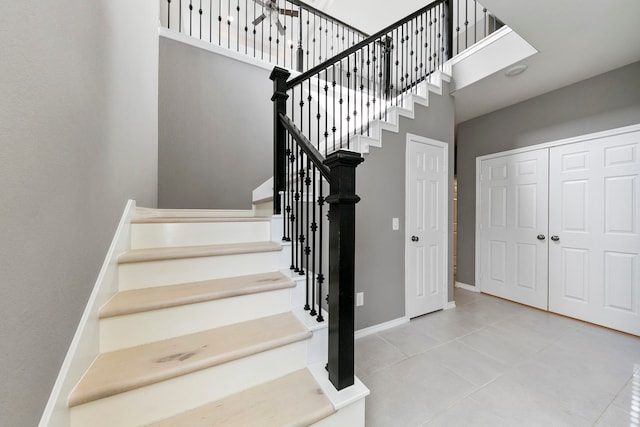 stairs featuring a high ceiling