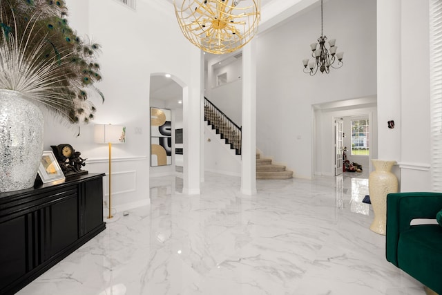 foyer entrance with an inviting chandelier and a high ceiling