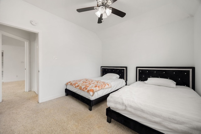 carpeted bedroom with vaulted ceiling and ceiling fan