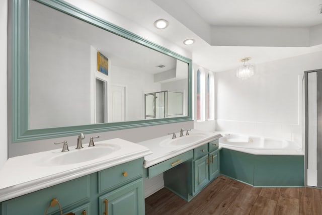 bathroom featuring wood-type flooring, separate shower and tub, and vanity