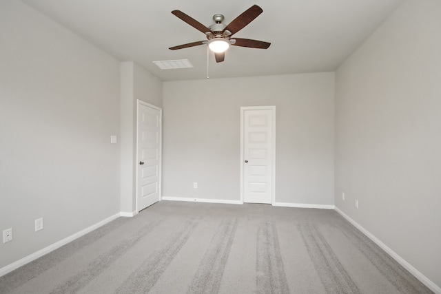 spare room with ceiling fan and light colored carpet