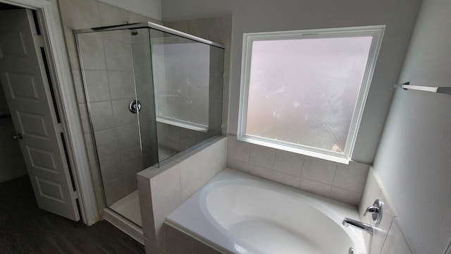 bathroom featuring separate shower and tub and hardwood / wood-style floors