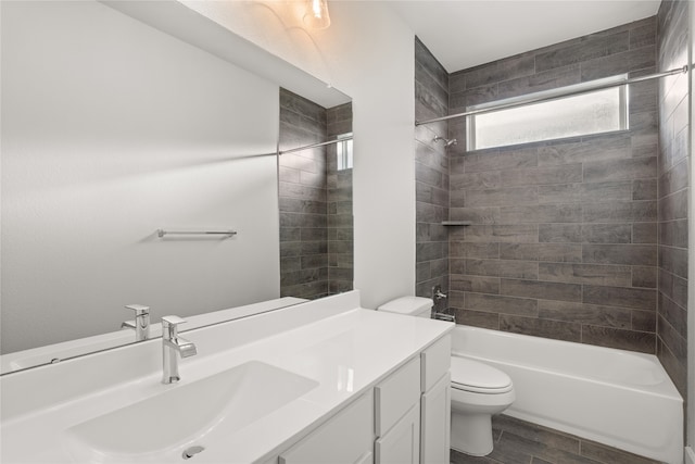 full bathroom featuring toilet, tiled shower / bath combo, vanity, and hardwood / wood-style floors