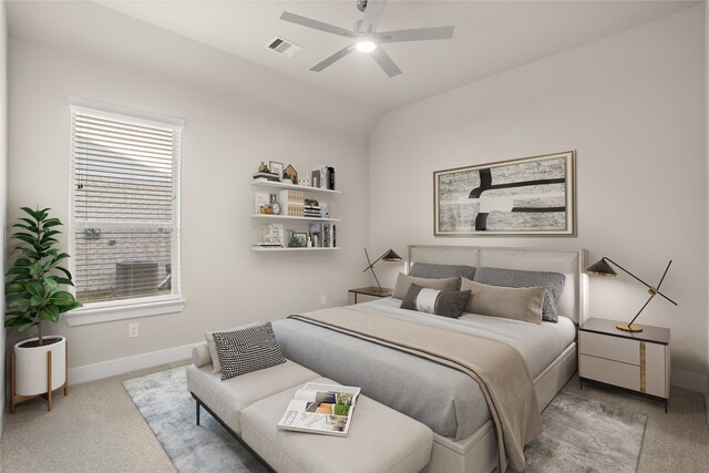 carpeted bedroom with ceiling fan and vaulted ceiling