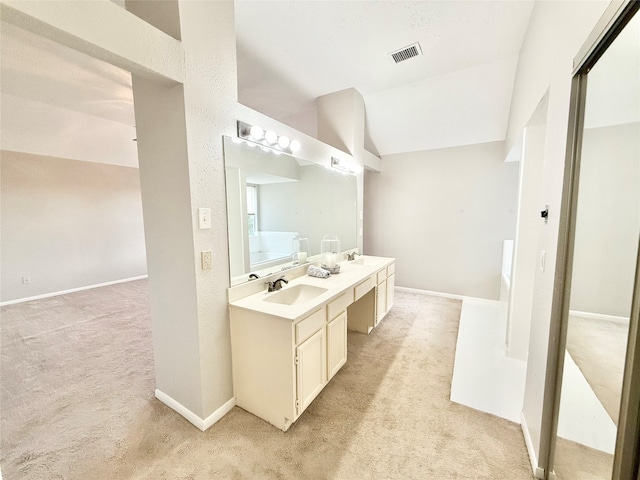 bathroom featuring vanity and vaulted ceiling